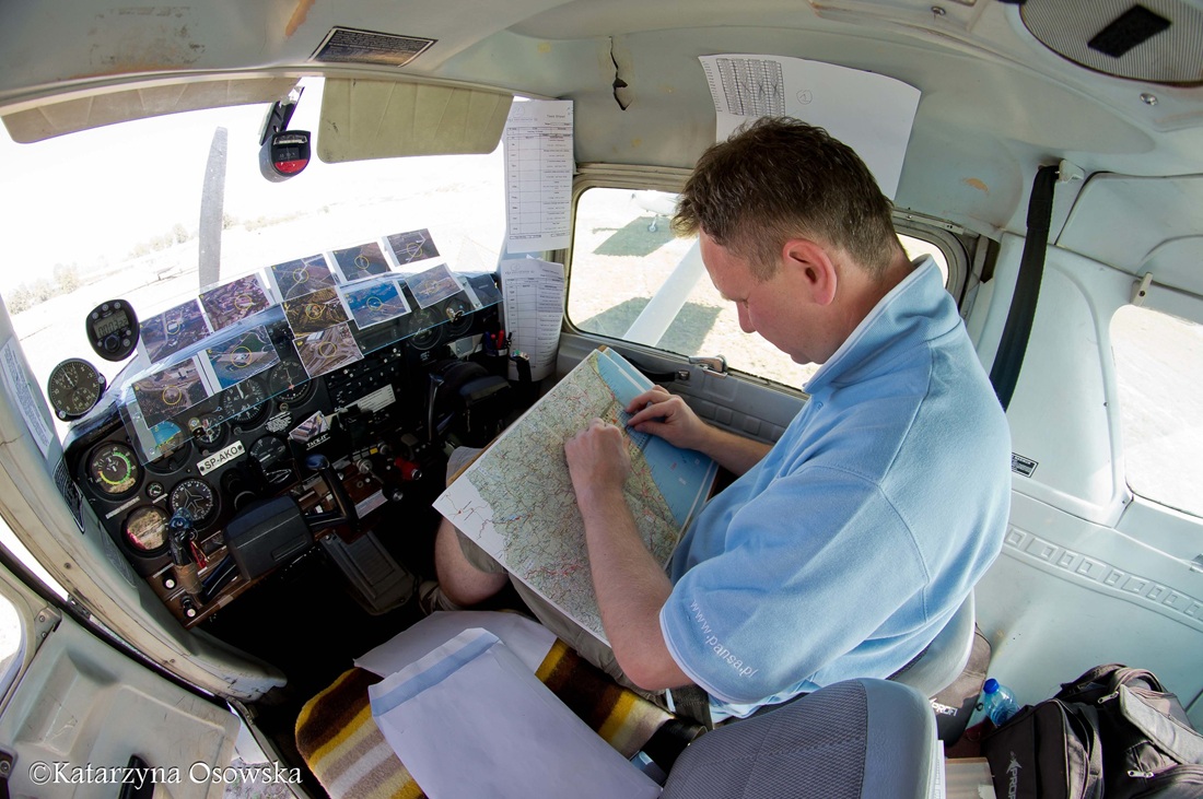 Rally Flying crew studies the flight map in the cockpit of a small aircraft